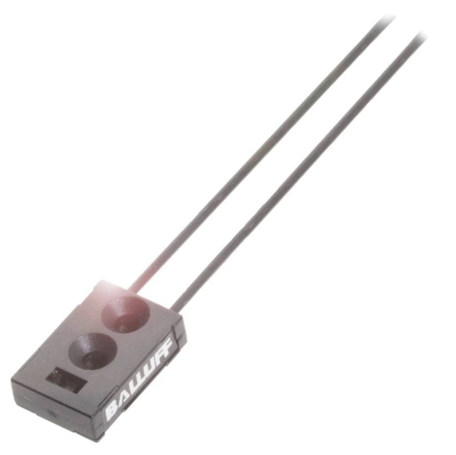 Obdĺžnikový, čierny senzor s nápisom 'Balluff', z ktorého vyčnievajú dva káble. Senzor je zobrazený mierne z boku.
