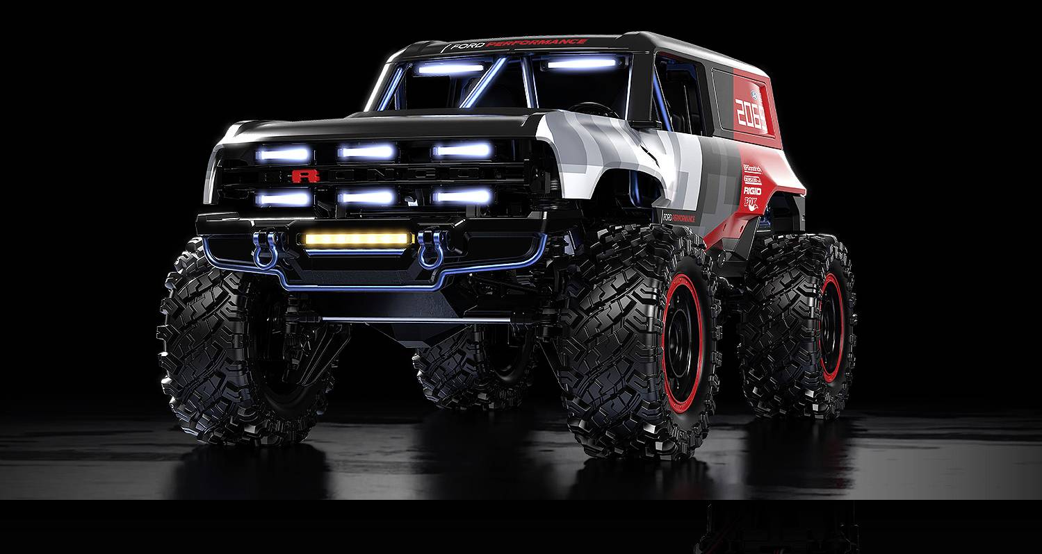 Veľký, futuristický monster truck s nadmerne veľkými pneumatikami a jasnými LED svetlami na reflexnom čiernom povrchu.