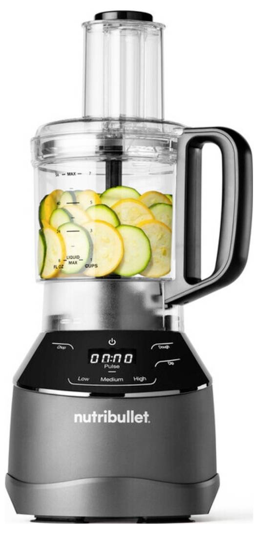 Nutribullet kuchynský robot s priesvitnou nádobou, digitálnym časovačom a rukoväťou, naplnený nakrájanou cuketou a tekvicou.