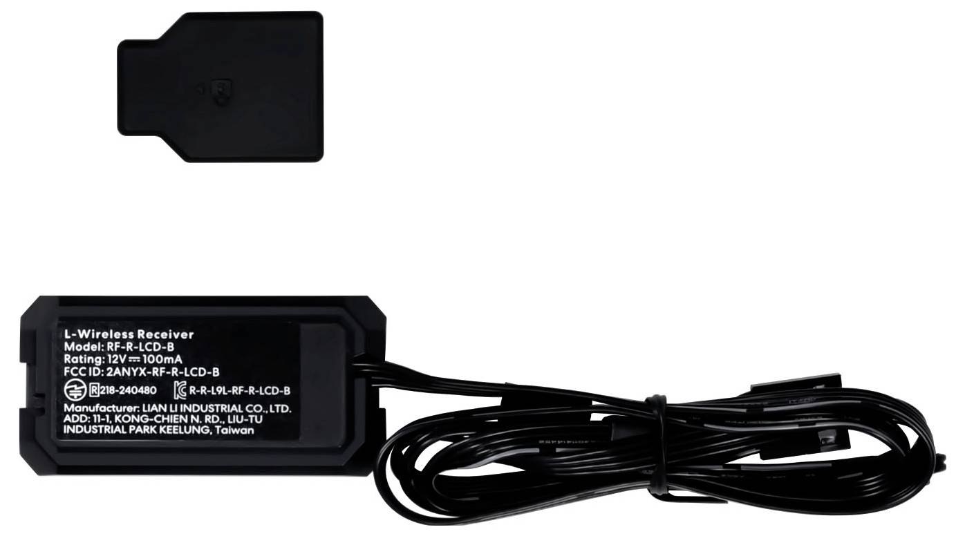 Čierny bezdrôtový prijímač s pripojenými káblami je zobrazený, označený ako "L-Wireless Receiver, Model: R-R-LCD-B". Nad ním leží ďalší tmavý plastový kryt.