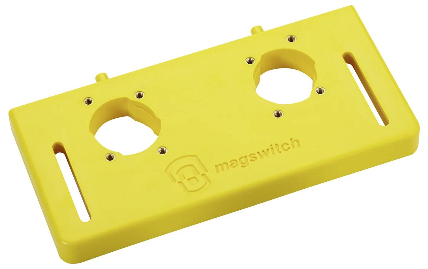 Žltá plastová základňa s dvoma okrúhlymi výrezmi a drážkami, s reliéfnym nápisom "magswitch". Používa sa ako montážna doska alebo šablóna pre nástroje.