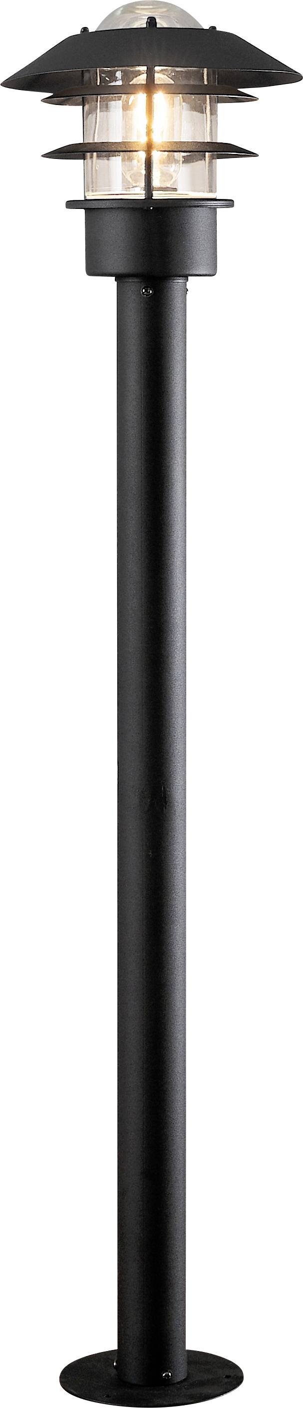 Vysoký, čierny pouličný lampa stĺp s priehľadným valcovým svetelným telesom a zakrytým vrchom, osvetlený teplou žiarovkou.