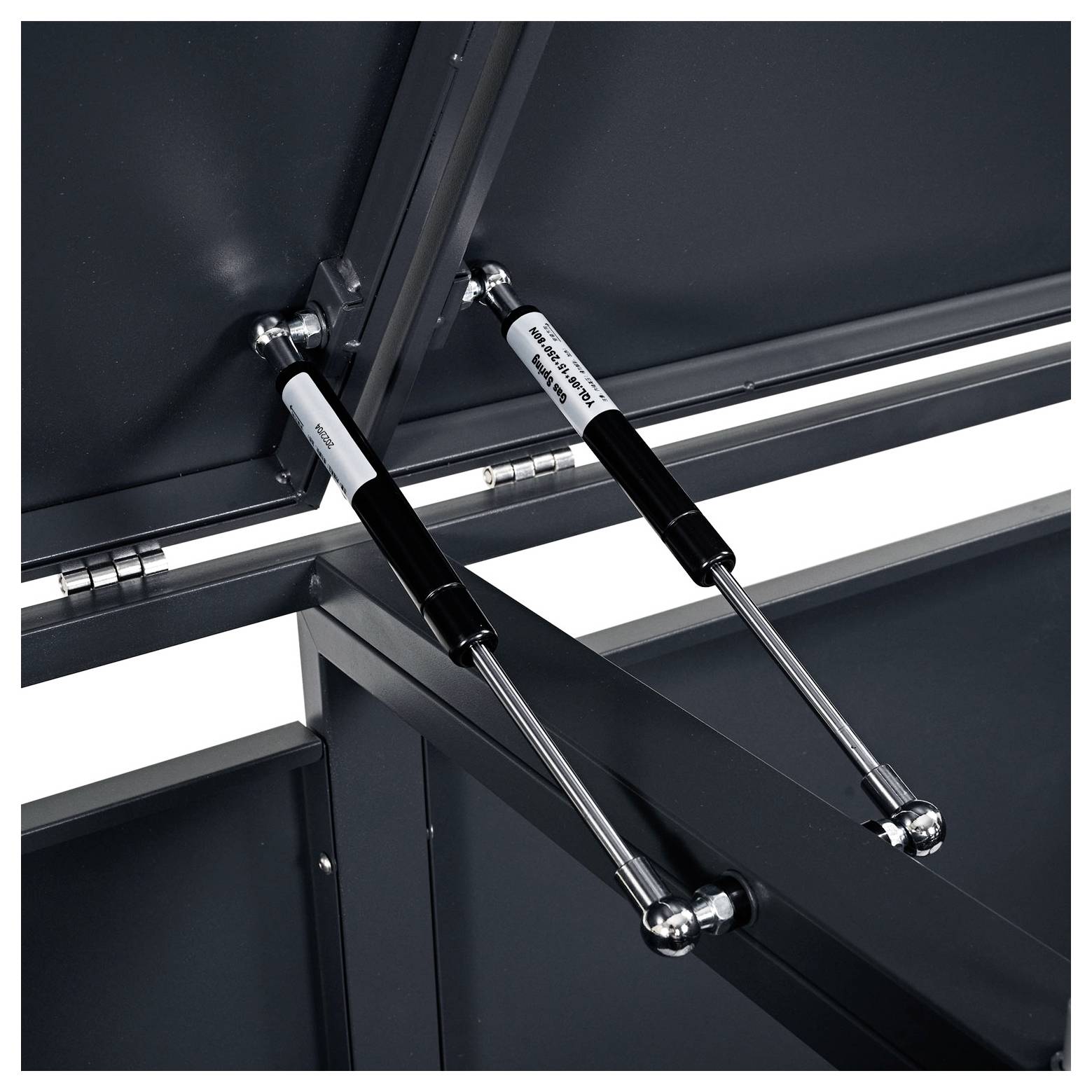 Plynové vzpery pripevnené k častiam kovového kabinetu, ktoré naznačujú mechanizmus otvárania a podopierania viek.
