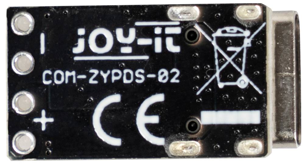 Malá elektronická doska plošných spojov označená nápisom 'joy-it COM-ZYPDS-02' so symbolmi označujúcimi polaritu a informácie o recyklácii.