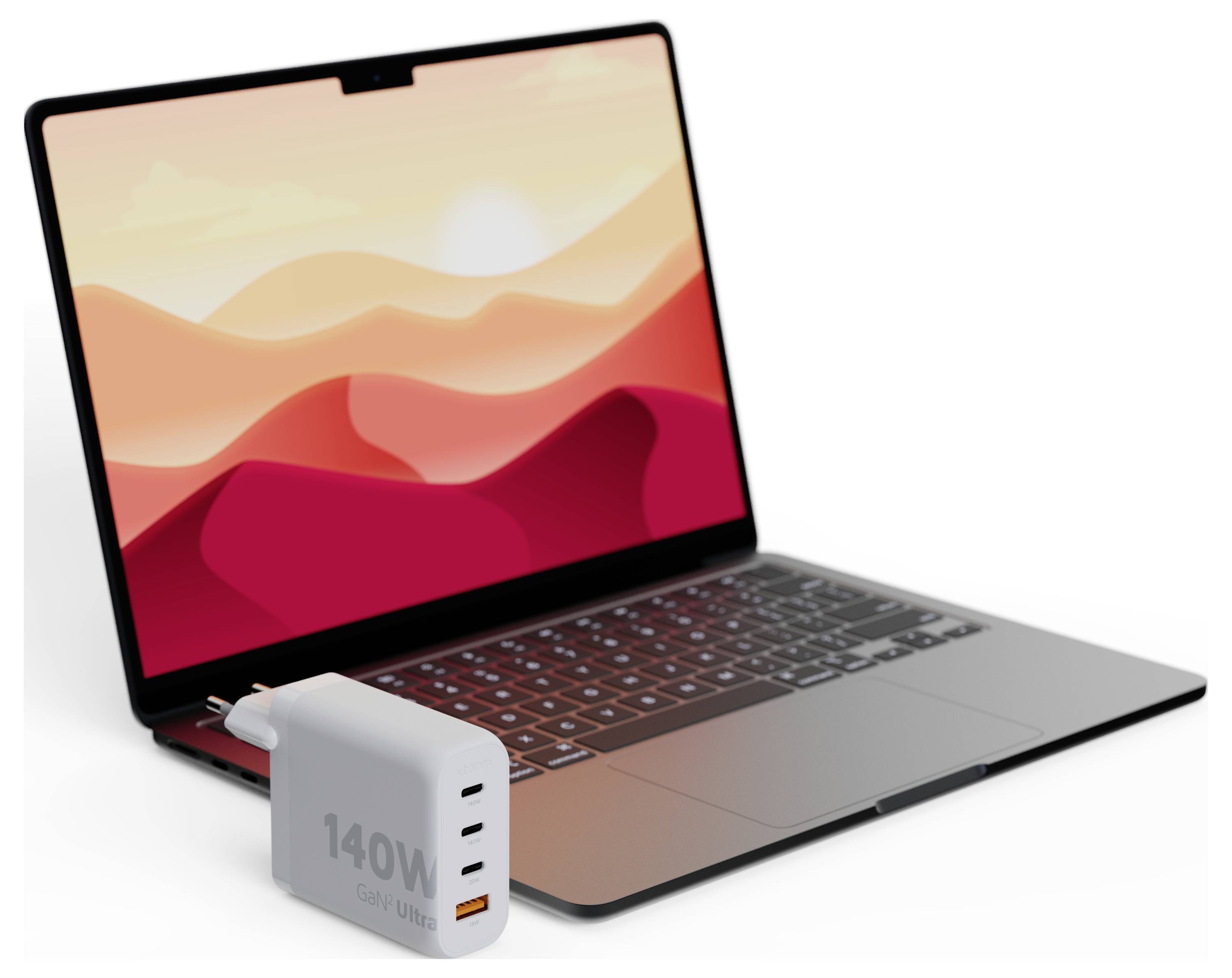Notebook s tapetou s motívom západ slnka, umiestnený vedľa 140W USB nabíjačky s viacerými portami na bielom pozadí.