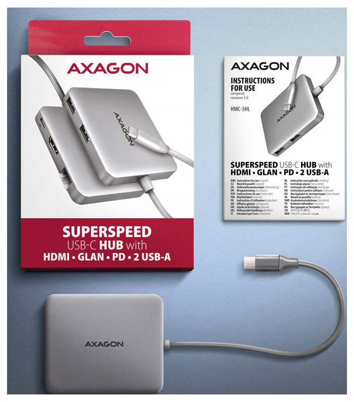 AXAGON SuperSpeed USB-C hub balenie, návod na obsluhu a striebristý hub s pripojením kábla a USB-C zásuvkou na modrom pozadí.