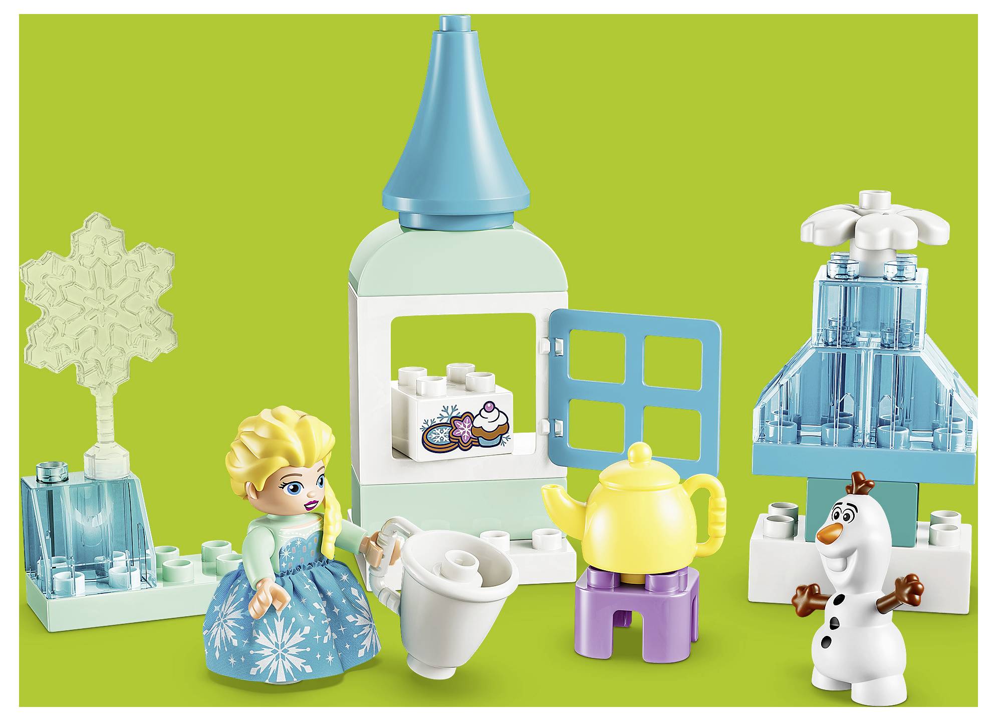 LEGO Disney Frozen sada s Elsou, Olafom, čajníkom, kúskami ľadového paláca a priehľadnými modrými zimných doplnkami na zelenom pozadí.
