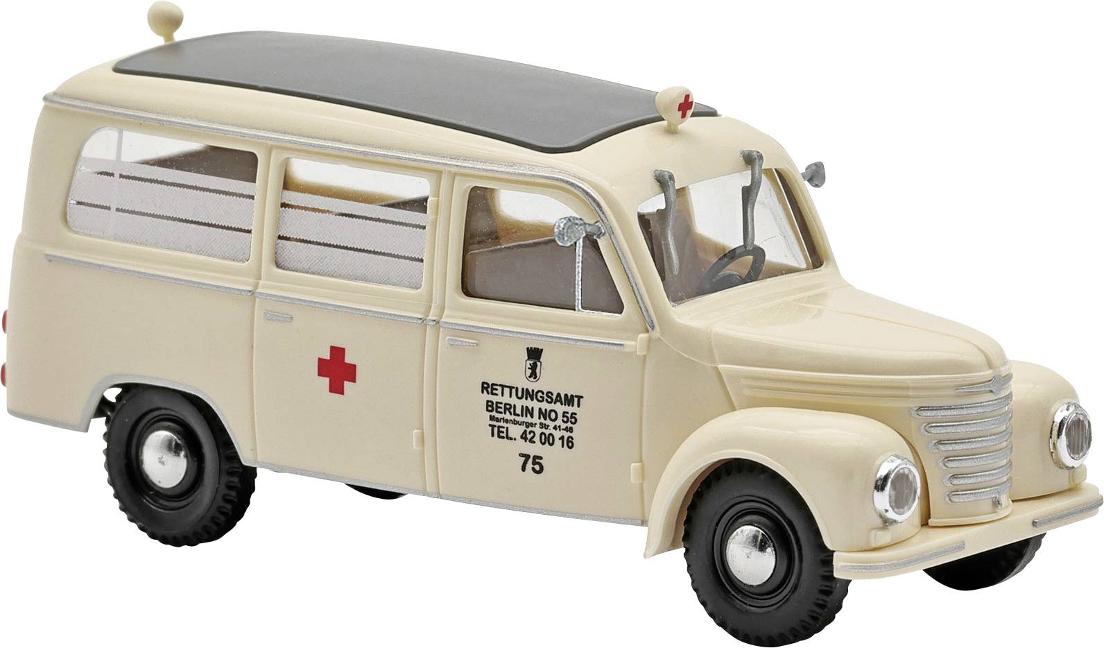 Béžová vintage ambulancia model furgonika s červenými kríži a nápismi „RETTUNGSAMT BERLIN" na boku.