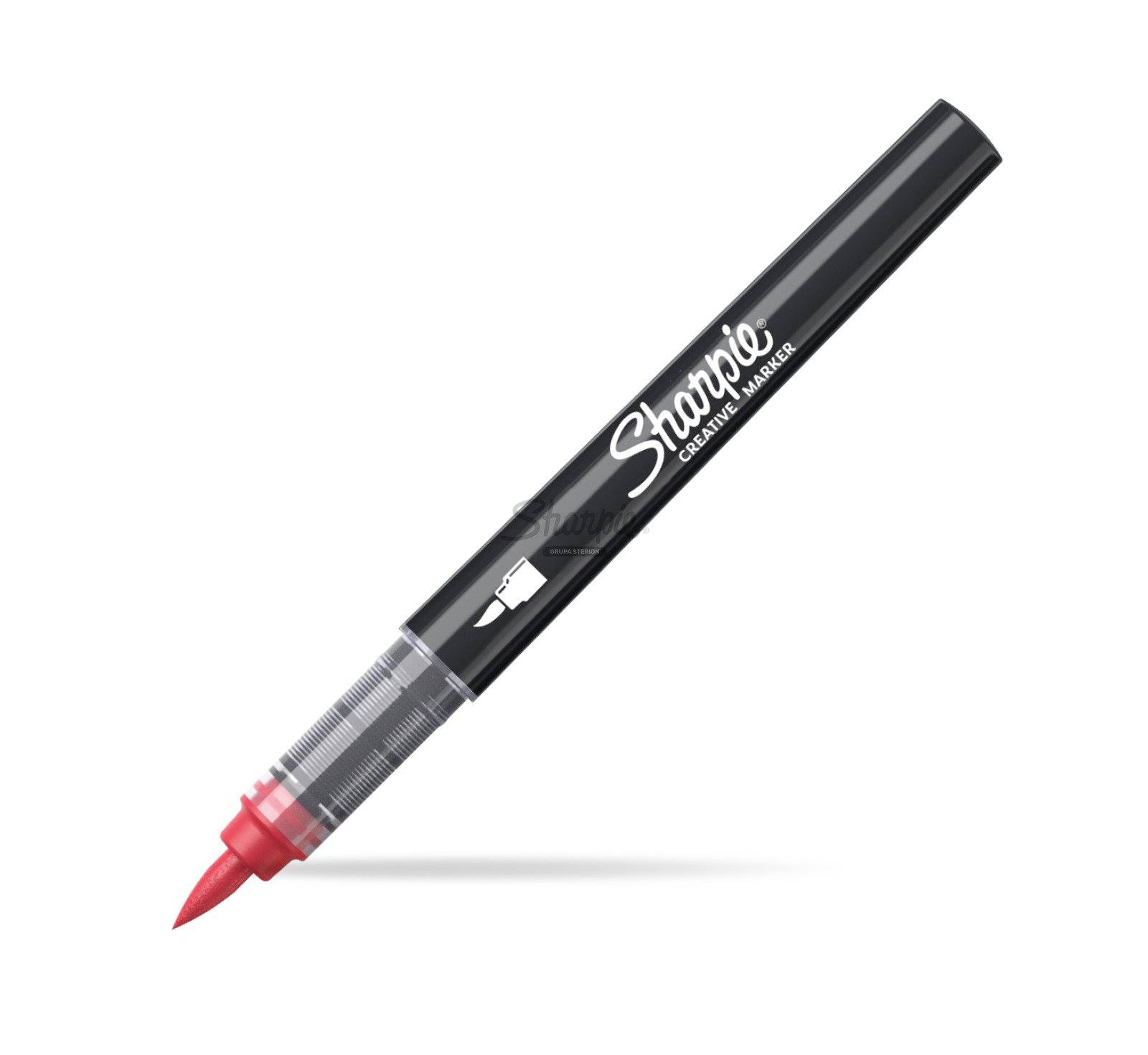 Čierny kreatívny popisovač Sharpie s červeným hrotom, zobrazený diagonálne na bielom pozadí.