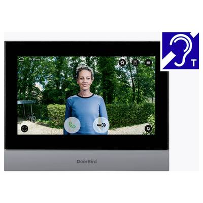 Obrazovka videozvoňovej jednotky DoorBird ukazujúca ženu pri vchodových dverách s ovládacími prvkami pre hovor, kľúč, nastavenia a zvonček; ikona dostupnosti pre počutie v pravom hornom rohu.