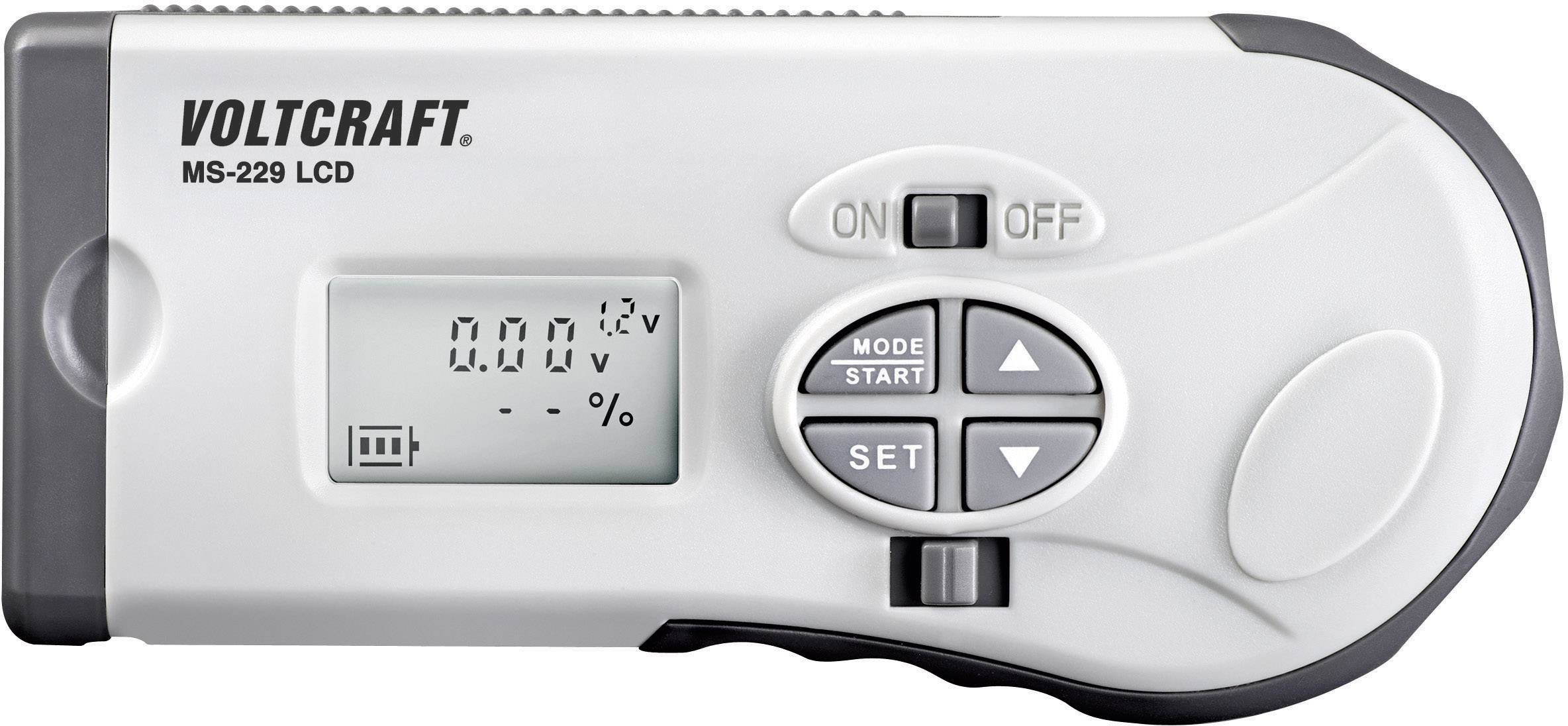 Digitálny multimeter na meranie napätia a odporu, s LCD displejom, tlačidlami pre voľbu módu a nastavení, značka 'Voltcraft'.