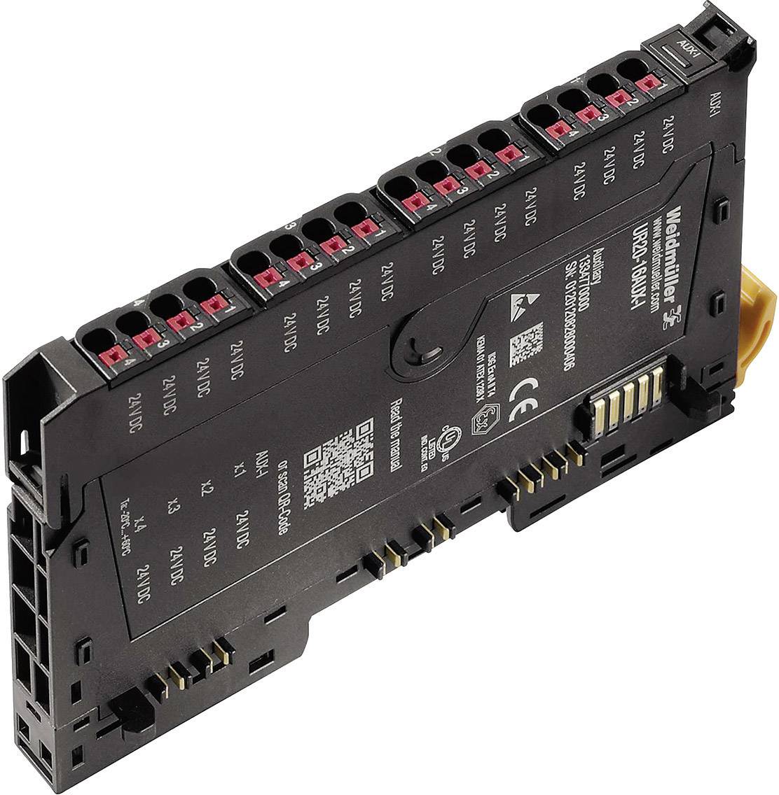 Elektronický modul s viacerými konektormi a označením '24VDC'. Zariadenie má vytlačené bezpečnostné a produktové informácie.