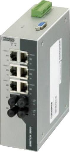 Sivý ethernetový prepínač so štyrmi ethernetovými portami a dvoma optickými portami. Hore zelený sieťový konektor. Zariadenie od spoločnosti Westermo.