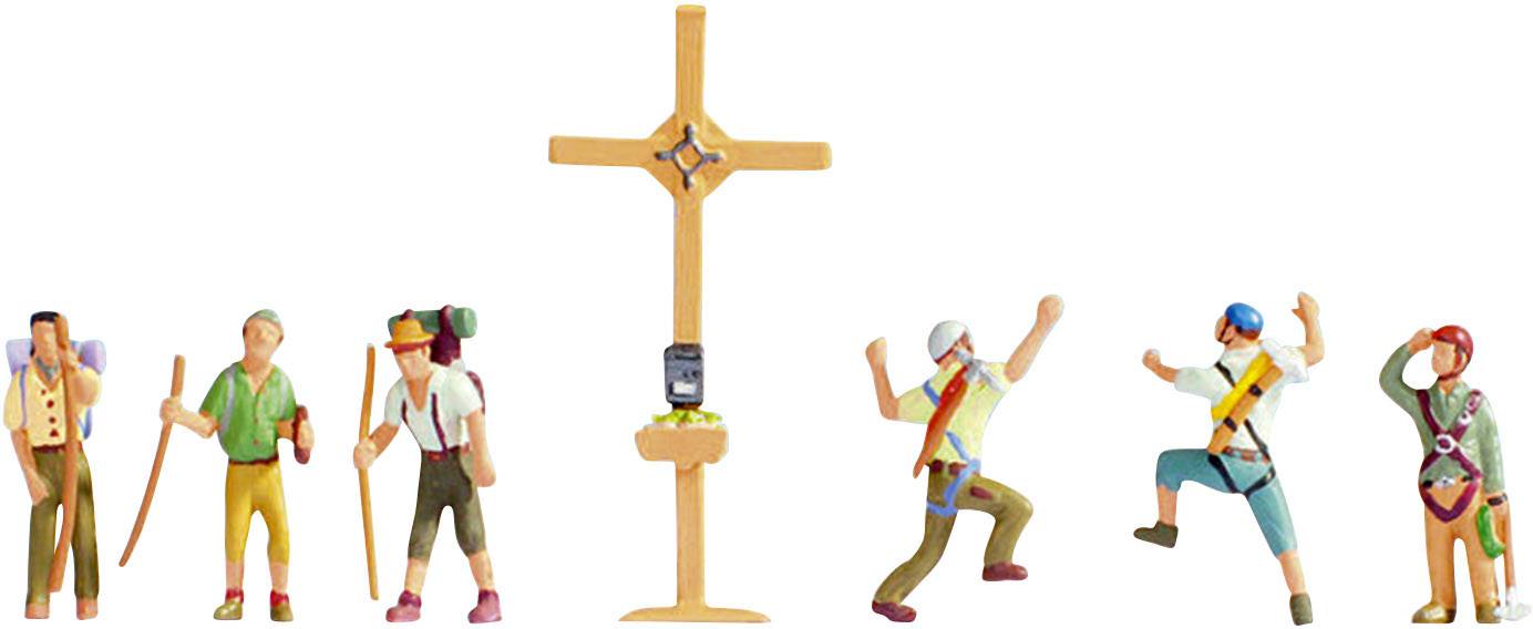 Niekoľko miniatúrnych figúrok stojí pri horskom výstupe okolo vrcholového kríža. Niektoré s nadšenímzdvíhajú ruky, iné sa opierajú o trekingové palice.
