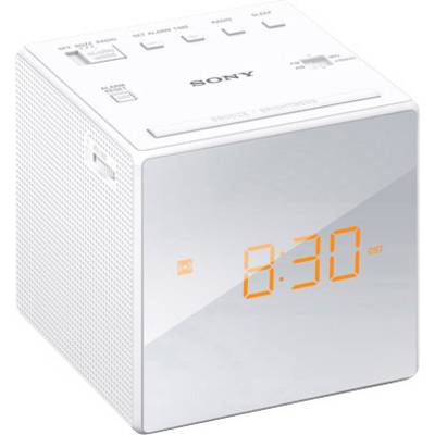 Biely digitálny rádiový budík s oranžovým LED displejom s časom '8:30'. Hore sa nachádzajú tlačidlá pre rádio, budík a jas.