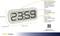 Digitálne hodiny s veľkým displejom ukazujú 23:59. Funkcie: presné rádiolokované hodiny, rôzne budíkové tóny, jednoduché nastavenie. Moderný dizajn.