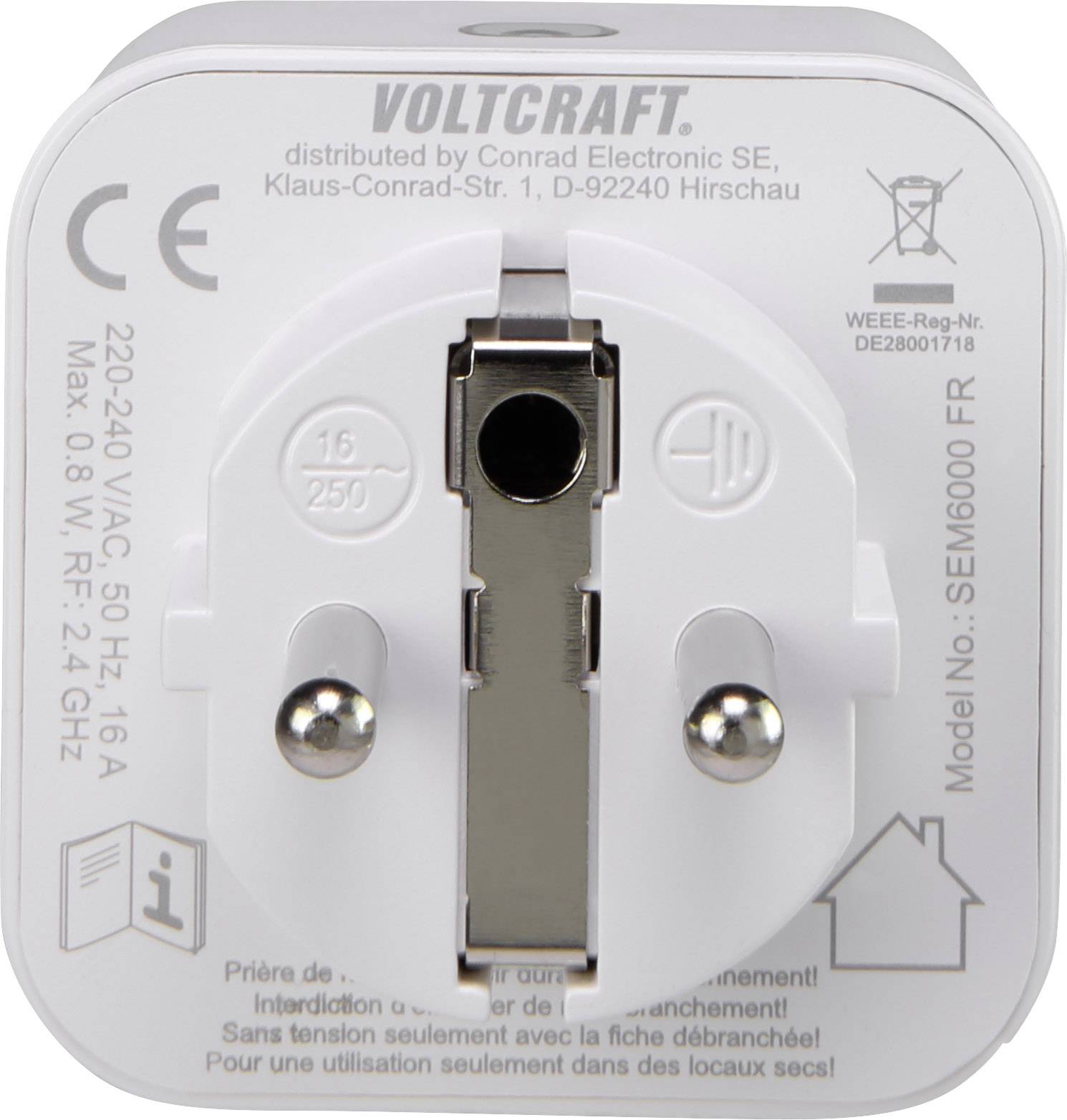 Biely adaptér od Voltcraftu s technickými údajmi a modelovým číslom na prednej strane. Zástrčkové kontakty v strede.