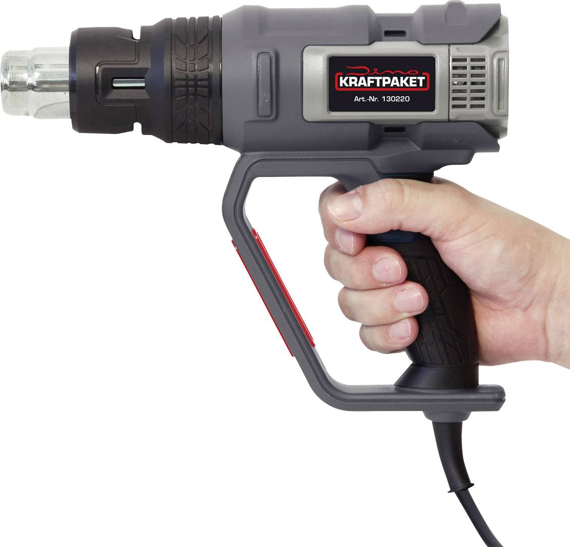 Ruka drží elektrickú teplovzdušnú pištoľ z boku.