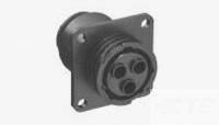 Guľatý elektrický konektor so štyrmi kolíkmi, namontovaný na štvorcovej doske so štyrmi upevňovacími otvormi.