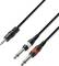 Čiernobiely audiokábel s 3,5 mm stereo jackom rozdeľujúci sa na dva 6,35 mm mono jacky v bielej a červenej farbe pre audio pripojenia.