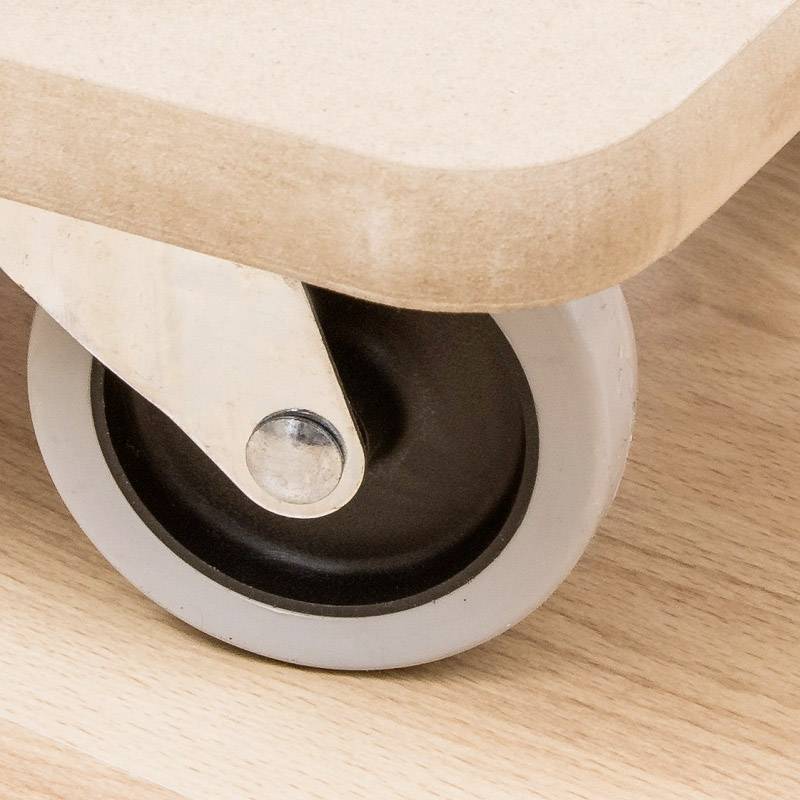 Drevený longboard s čiernym kolesom na svetlom drevenom povrchu.