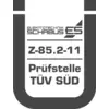 Logo s nápisom 'ELEKTROTECHNIKA SCHABUS', nižšie 'Z-85.2-11', nasledované 'Skúšobné miesto TÜV SÜD', orámované štylizovaným U.