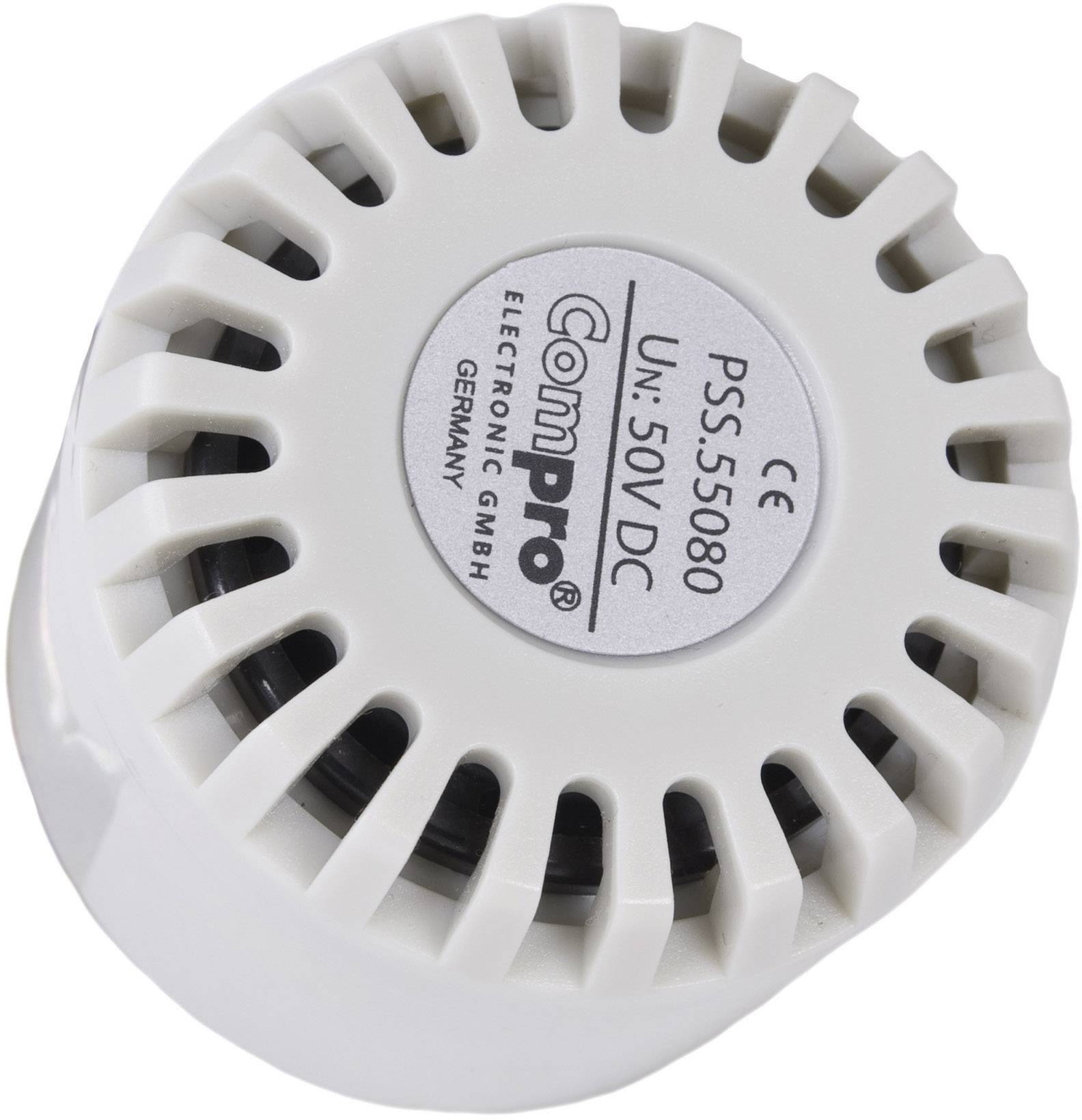 Biely elektronický signalizátor od spoločnosti ComPro, model PSS-5560, určený pre napätie 5 až 50 V DC, s vetracími štrbinami.