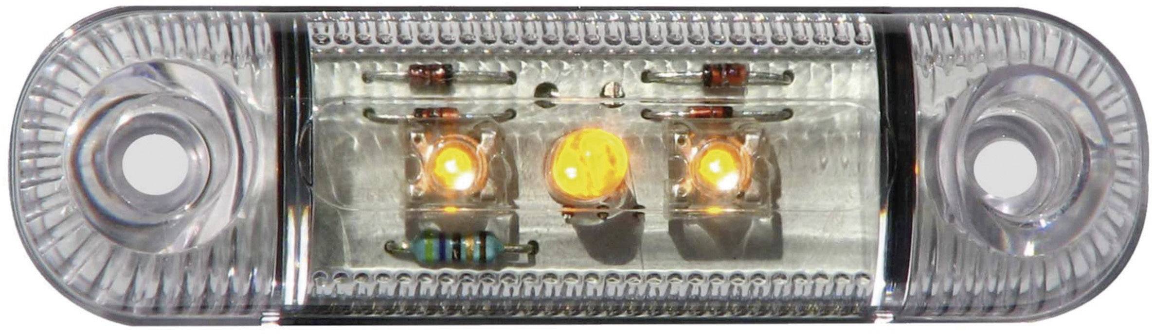 Obdĺžnikové, priehľadné LED svetlo s tromi svietiacimi oranžovými diódami a niekoľkými elektronickými súčiastkami vo vnútri.