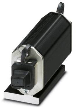 Črn, pravokoten elektronski element s stikalom, nameščen na srebrni in črni osnovni plošči.
