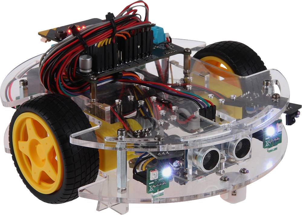 Prosojni robot z rumenimi kolesi in številnimi kabli je postavljen na mizo. Robot se zdi, da ima spredaj nameščene senzorje.