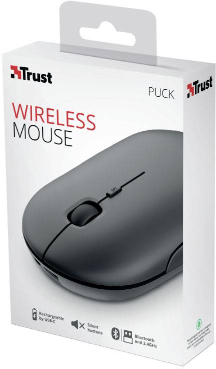 Škatla z brezžično miško 'Trust Puck' v črni barvi. Lastnosti: možnost ponovnega polnjenja prek USB, tihe tipke, Bluetooth in 2,4 GHz.