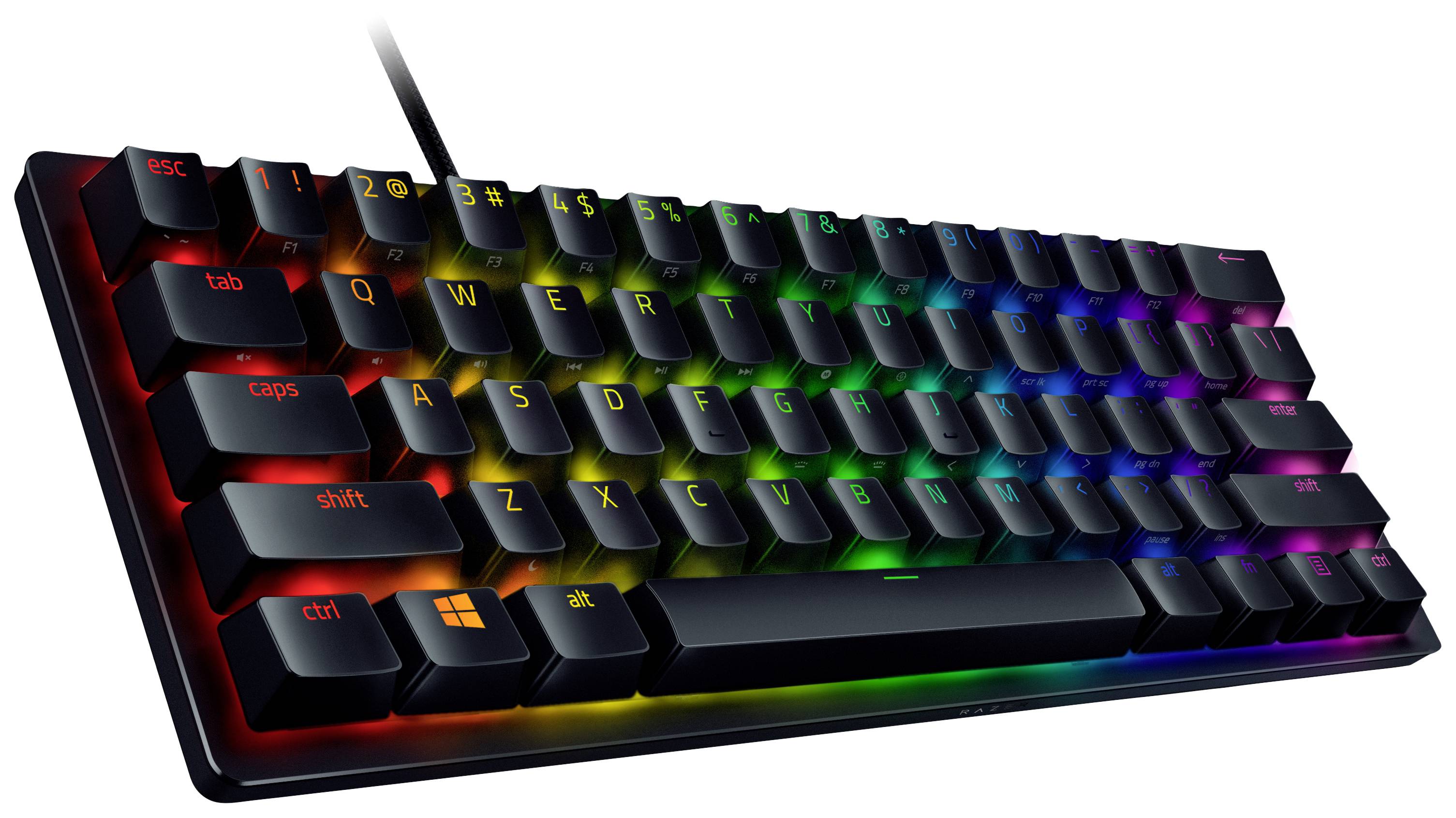 Črna mehanična tipkovnica z RGB-osvetlitvijo, ki prikazuje svetleče barvne vzorce na tipkah v temnem okolju.