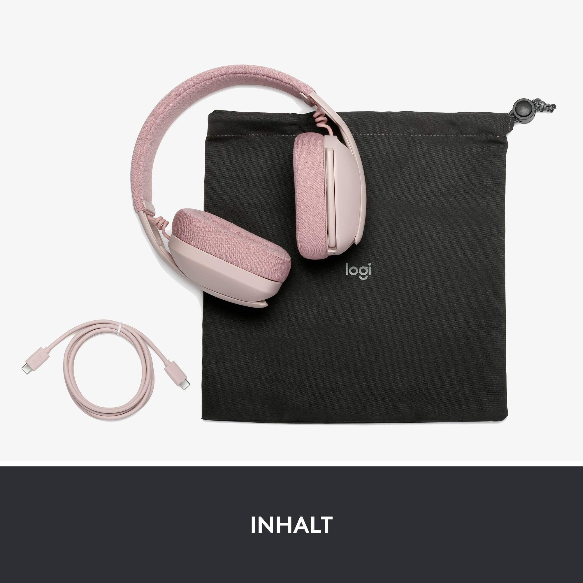 Roza over-ear slušalke z USB kablom in črno transportno torbo z logotipom 'logi', postavljene na belem ozadju.