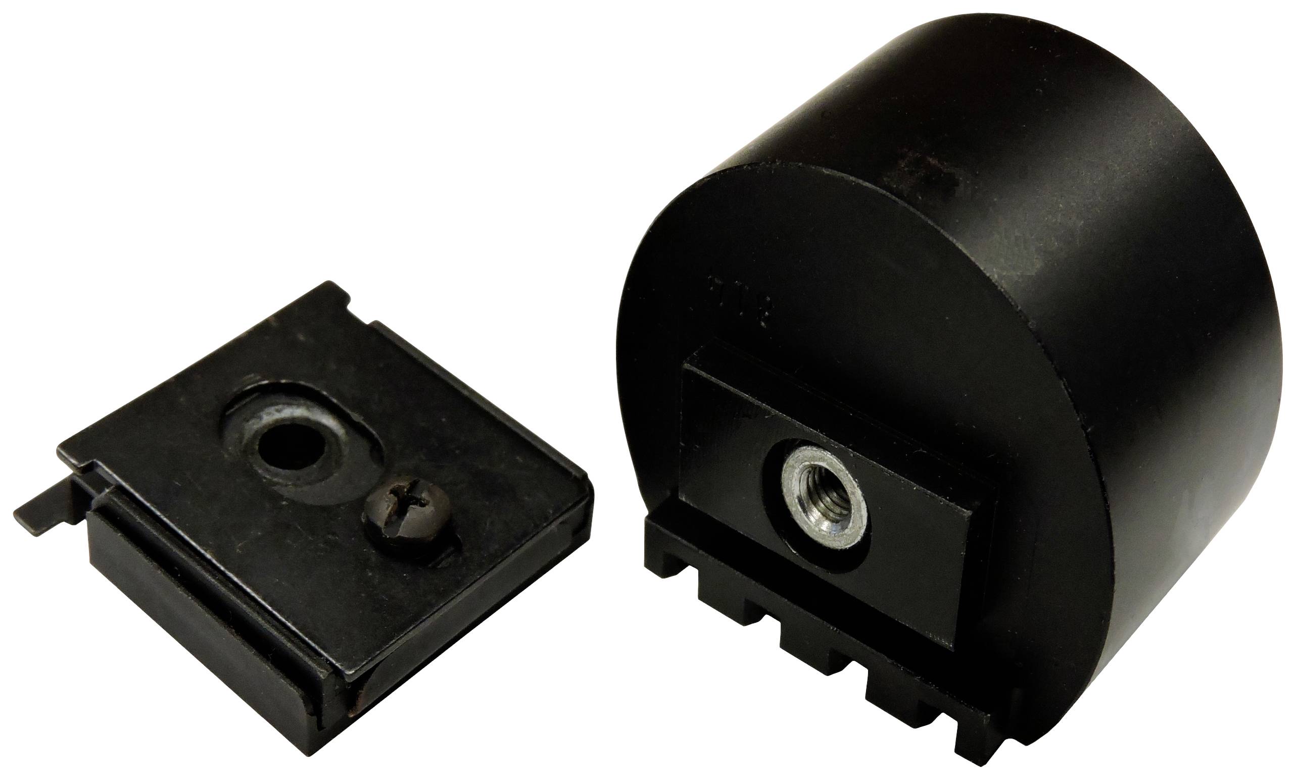 Črni kovinski del, sestavljen iz okroglega in kvadratnega elementa, verjetno mehanski ali elektronski komponenti.