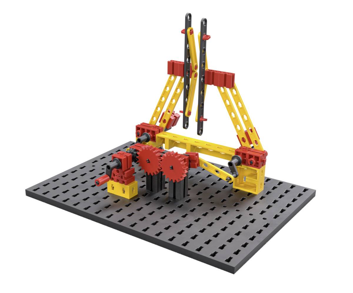 Konstrukcijski set igrač z rumenimi in rdečimi deli, ki prikazuje preprosto napravo z zobniki in vzvodi na sivi podlagi.