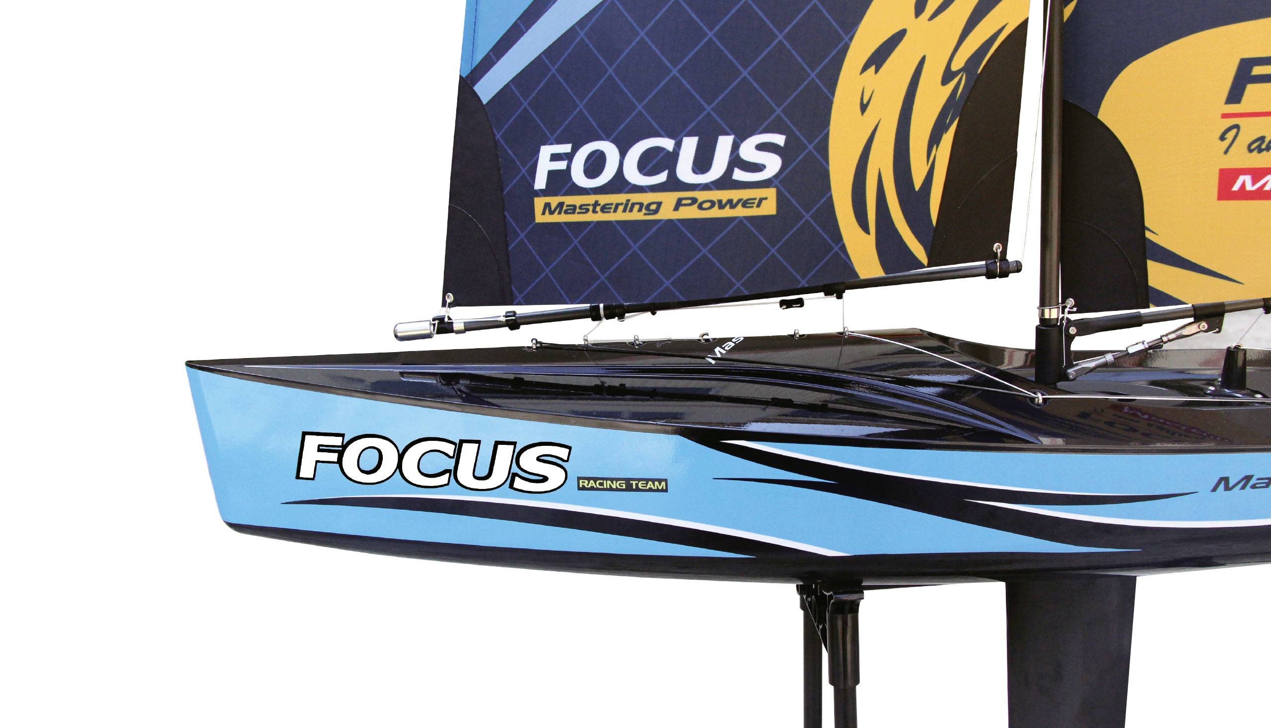 Regata jadrnica z modro-črnim trupom. Napis 'FOCUS Mastering Power'. Dizajn trupa z dinamičnimi linijami in logotipom.