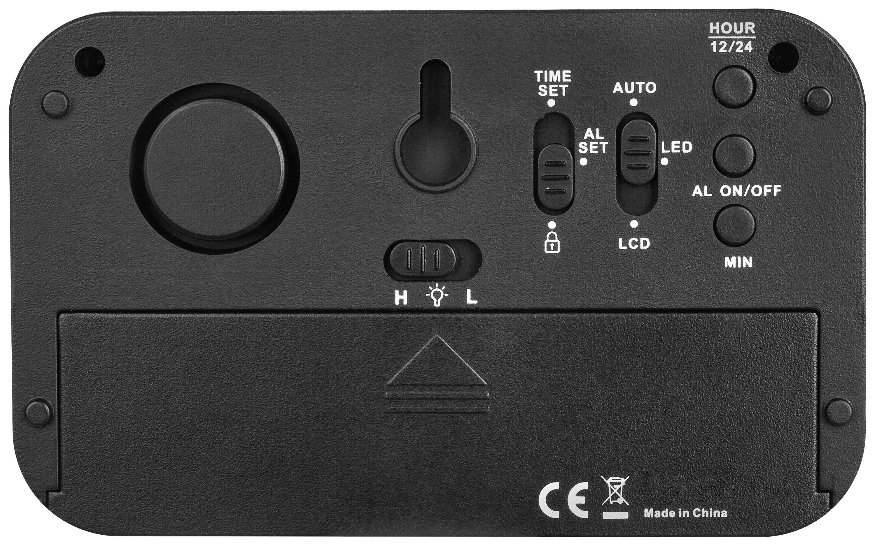 Elektronska naprava z nastavitvenim gumbom za 'Nastavitev časa', 'Samodejno', 'Nastavitev alarma', 'LCD', 'LED' in 'VKLOP/IZKLOP'. Izdelano na Kitajskem.