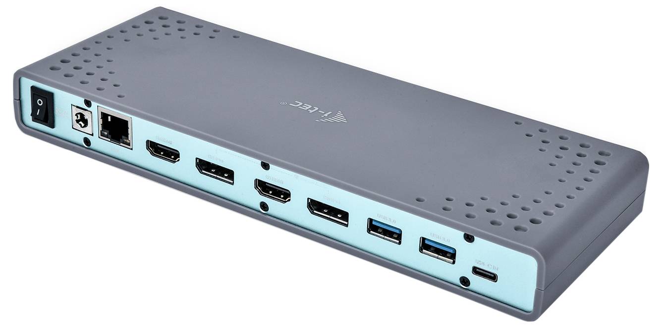 Siva USB-priklopna postaja z več vrstami priključkov: Ethernet, HDMI, USB-A in USB-C. V pisarni se uporablja za prenos podatkov in povezovanje naprav.