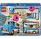 'Lego komplet 60452: Set prodajnega vozička z donutom, mini figuricami in prodajnim pultom, plaža v ozadju, vesele scene.'