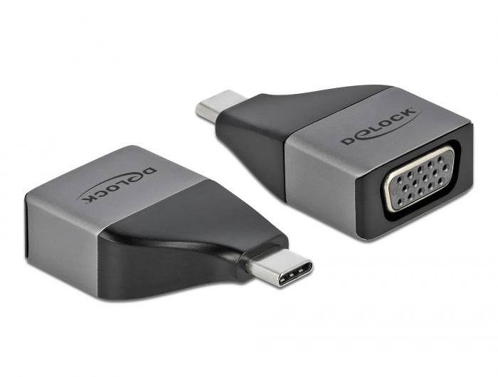 Dva adapterja USB-C na VGA, srebrne in črne barve, z logotipom 'Delock' na zgornji strani. Omogočata priklop VGA-kabla na napravo z USB-C priključkom.