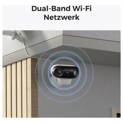 Varnostna kamera, nameščena na vogalu pod streho, ki oddaja modre Wi-Fi signale, z besedilom 'Dual-Band Wi-Fi Omrežje' zgoraj.