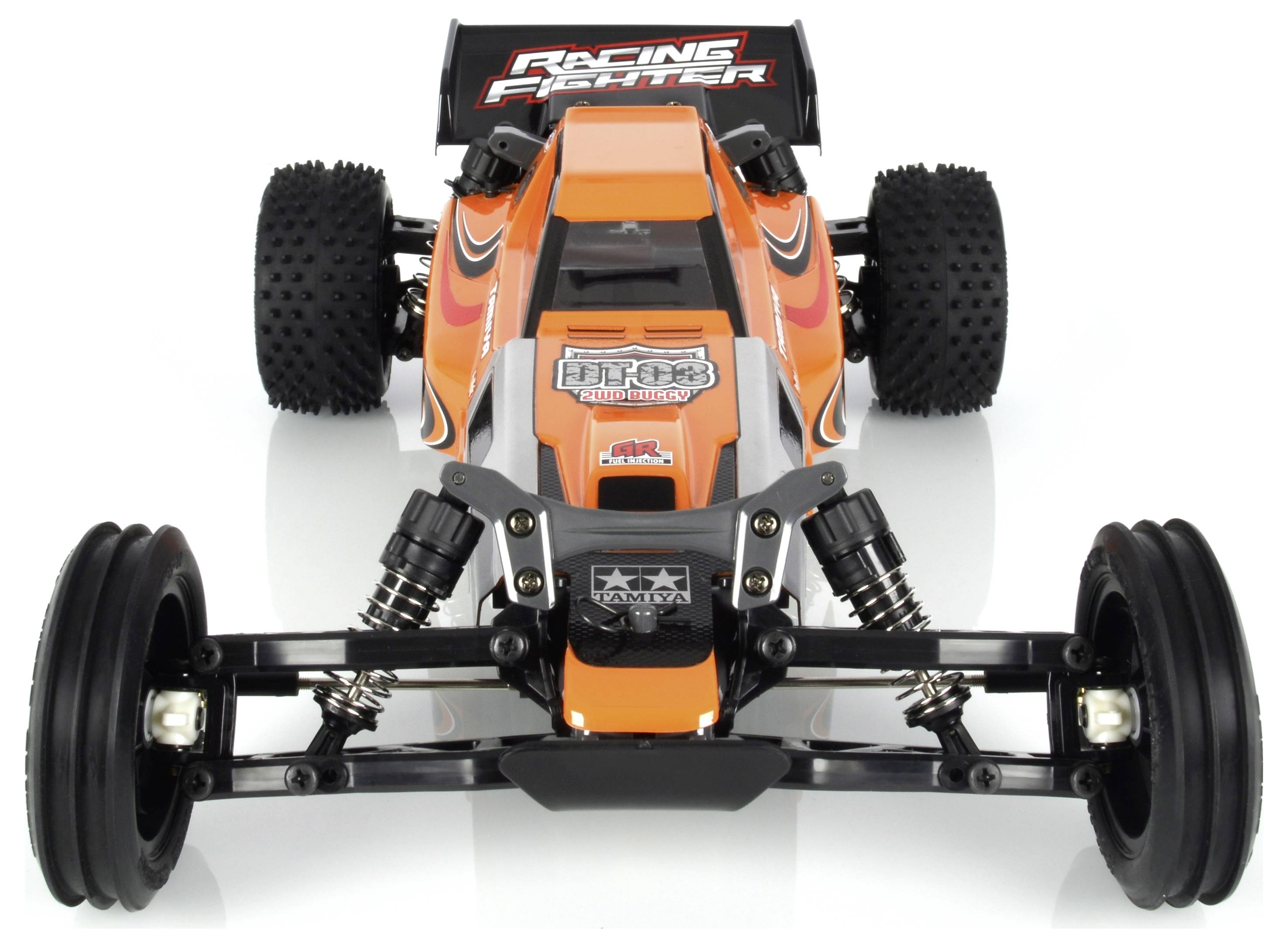 Oranžno-črn daljinsko upravljan model dirkalnega vozila z velikimi pnevmatikami in napisom 'Racing Fighter'.