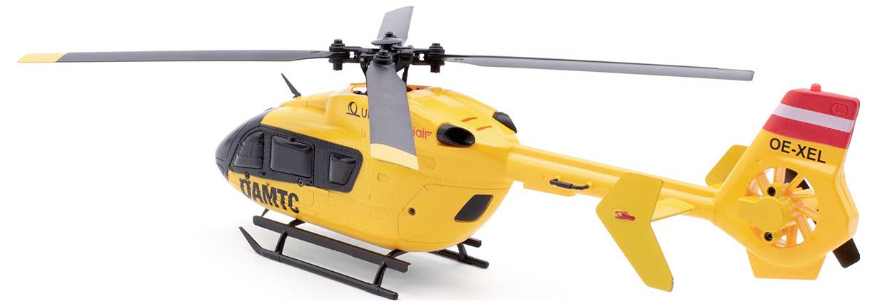 Rumena maketa reševalnega helikopterja z napisom 'ÖAMTC' na strani, pogled od zadaj.