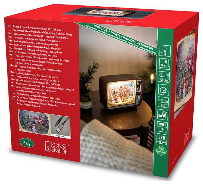 Škatla prikazuje retro televizijsko dekoracijo z LED osvetljeno božično sceno v notranjosti. Vključuje podrobnosti, kot so funkcije časovnika in zahteve glede baterij.