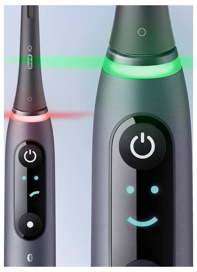 Dve električni zobni ščetki z light indikatorji; leva prikazuje kislo naličje z rdečo lučko, desna pa nasmejano naličje z zeleno lučko.