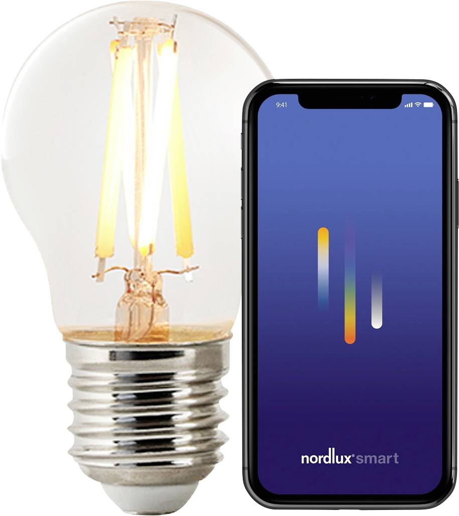 Pametni telefon z aplikacijo 'nordlux smart' poleg prozorne LED svetilke, kar nakazuje povezljivost za pametno krmiljenje razsvetljave.