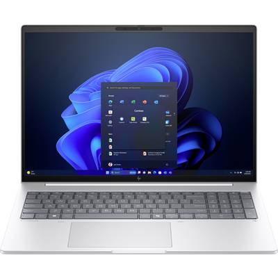 Prenosni računalnik s srebrno ohišjem prikazuje zaslon operacijskega sistema Windows z modro abstraktno ozadjem in odprtim menijem Start.