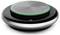 'Črni krožni konferenčni zvočnik s srebrnim vrhom in tipkalnimi kontrolami, vključno s tipkami za klic in glasnost, poudarjen v zeleni barvi.'