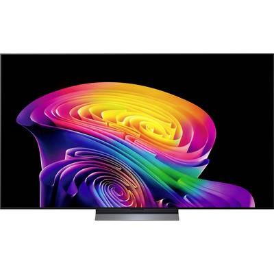 Pisana abstraktna vrtinčasta tapeta prikazana nawide-screen monitorju pred črno ozadjem.