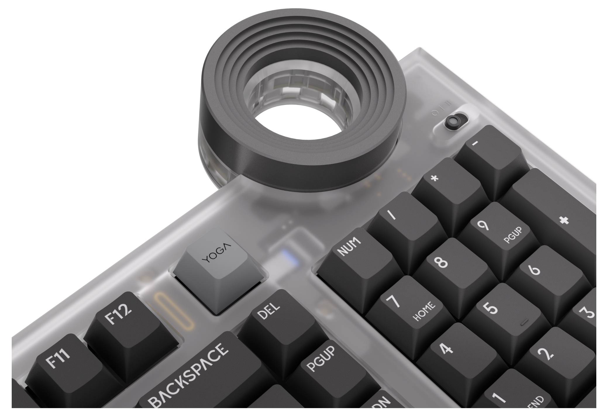 Detajlni pogled na prozorno mehikansko tipkovnico s črnimi tipkami, velikim okroglim povečevalnim lečo in vidnimi oznakami, kot so BACKSPACE, DEL, PGUP in NUM.